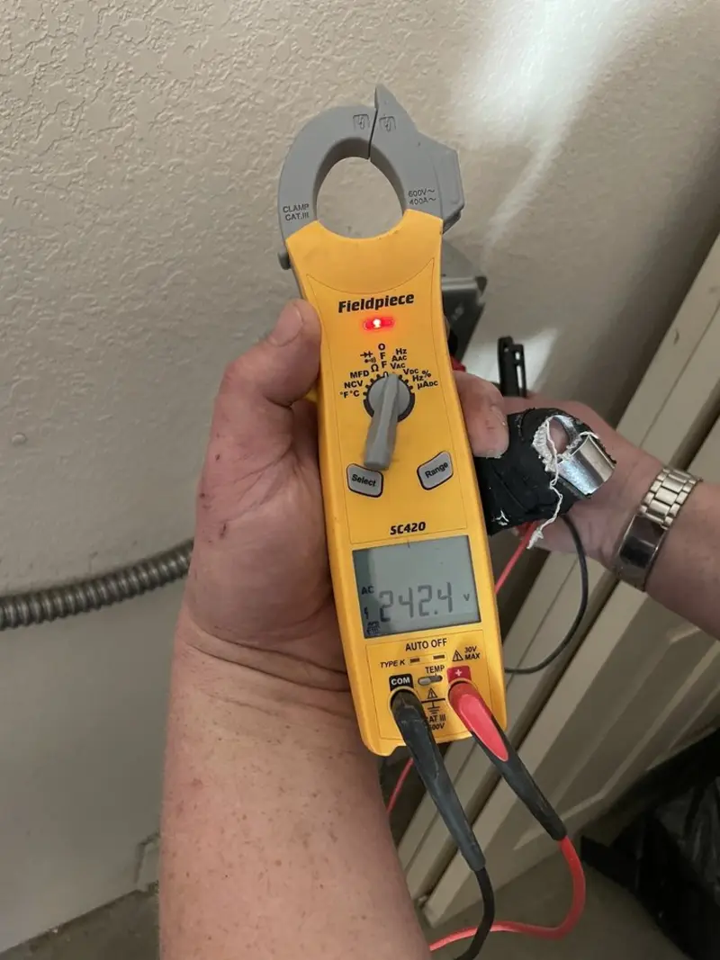 Voltage testing with clamp meter during Electrical Installation Services in Combes